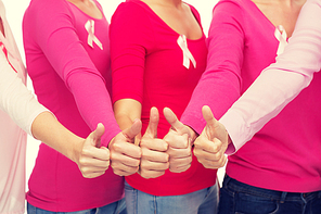 healthcare, people, gesture and medicine concept - close up of women in blank shirts with pink breast cancer awareness ribbons showing thumbs up over white background