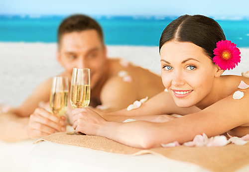 picture of couple on the beach drinking champagne