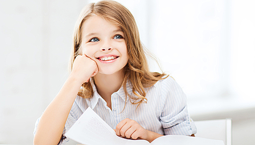 education and school concept - little student girl studying at school