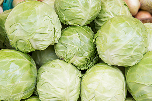 sale, harvest, food, vegetables and agriculture concept - close up of cabbage at street market