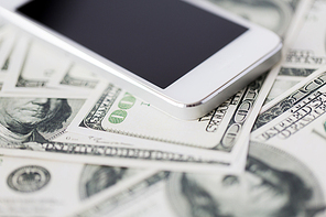 business, finance, technology and e-commerce concept - close up of smartphone with black blank screen and dollar money