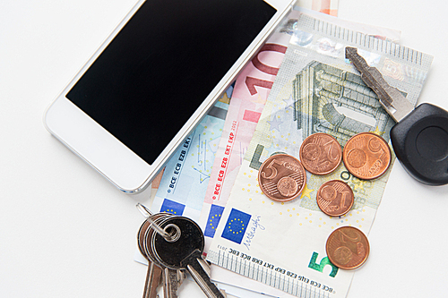 personal stuff and objects concept - close up of smartphone, euro money and keys on table