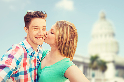 travel, tourism, technology, love and people concept - smiling couple kissing and taking selfie over washington white house background