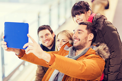 people, friendship, technology and leisure concept - happy friends taking selfie with tablet pc computer on skating rink