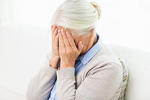 health care, pain, stress, age and people concept - senior woman suffering from headache or grief