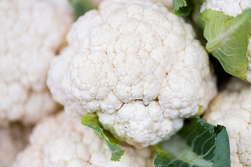 sale, harvest, food, vegetables and agriculture concept - close up of cauliflower at street market