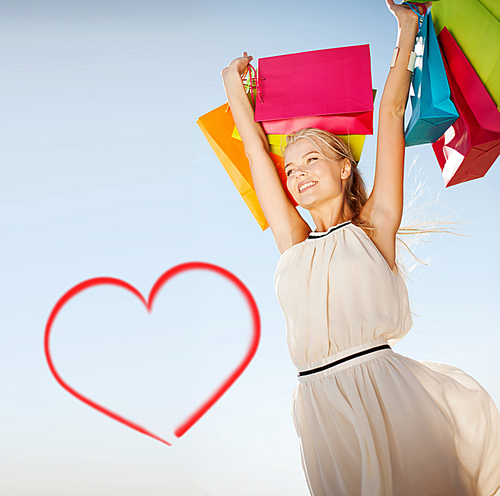 shopping and tourism concept - woman with shopping bags