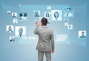 business, people, communication and social network concept - businessman touching contacts icons on virtual screen from back over blue background