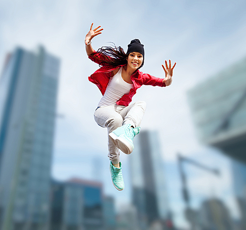 sport, dancing and urban culture concept - beautiful dancing girl jumping