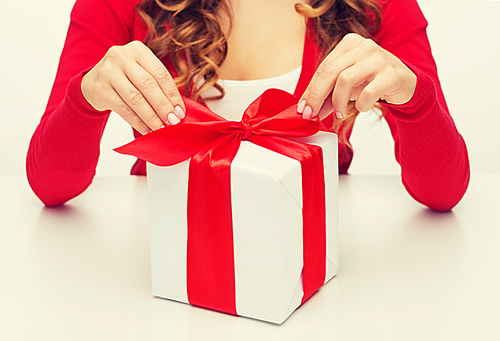 christmas, x-mas, happiness, winter and people concept - woman hands opening gift box