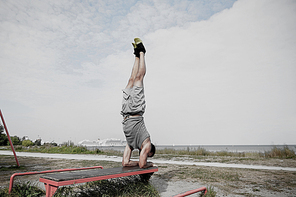 fitness, sport, training and lifestyle concept - young man exercising on bench outdoors