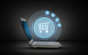 technology, business, e-commerce and sale concept - open laptop computer with shopping trolley icon projection over dark gray background