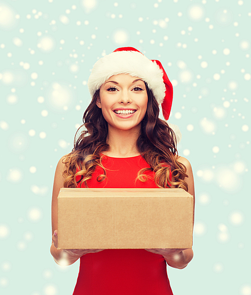christmas, x-mas, winter, happiness concept - smiling woman in santa helper hat with parcel box