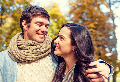 love, relationship, family and people concept - smiling couple hugging in autumn park