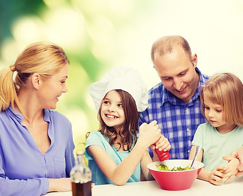 food, family, children, hapiness and people concept - happy family with two kids making dinner at home