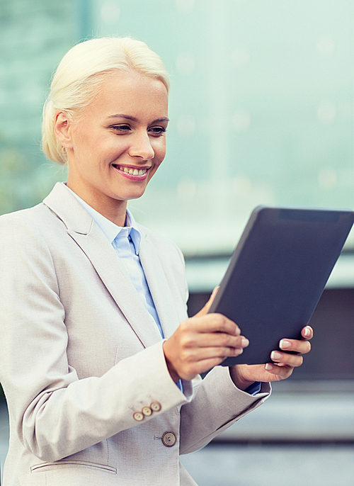 business, education, technology and people concept - smiling businesswoman working with tablet pc computer on city street