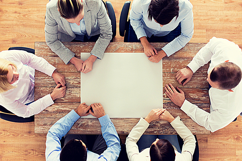 business, people and team work concept - close up of creative team sitting at table in office