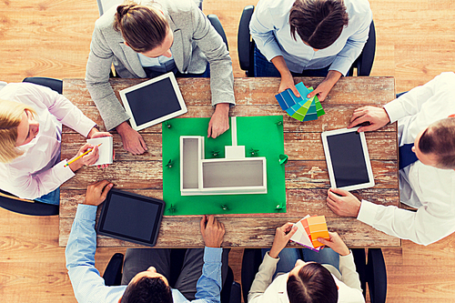 business, people and team work concept - close up of creative team with project layout, color palettes and tablet pc computers sitting at table in office