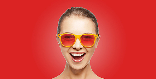 people, summer accessories and pop art concept - happy screaming teenage girl in shades over red background