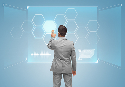 business, people, technology and networking concept - businessman touching virtual screen with network from back over blue background