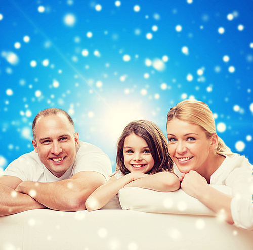 family, childhood, holidays and people - smiling mother, father and little girl over blue snowy background