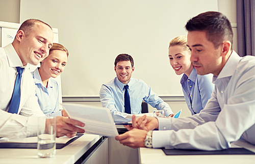 business, people and teamwork concept - group of smiling businesspeople meeting in office