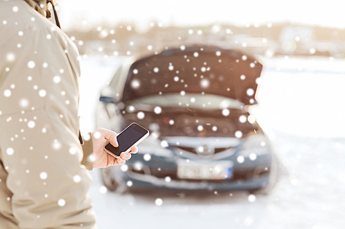 transportation, winter, people and vehicle concept - closeup of man with broken car and cell phone