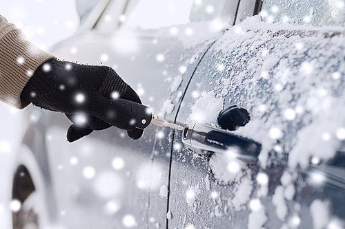 transportation, people, season and ownership concept - close up of man with car key outdoors