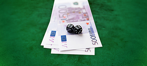 casino, gambling and fortune concept - close up of black dice and euro cash money over green felt surface background