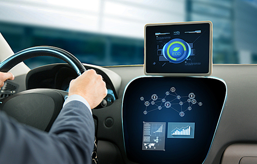 transport, business trip, technology and people concept - close up of young man with tablet pc computer driving car and using eco system mode