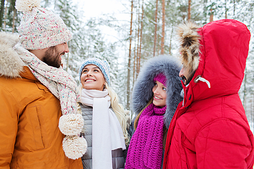 love, relationship, season, friendship and people concept - group of smiling men and women talking in winter forest