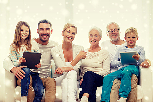 family, generation, technology and people concept - smiling family with tablet pc computers at home