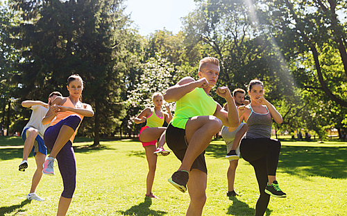 fitness, sport, martial arts, self-defense and healthy lifestyle concept - group of teenage friends or sportsmen exercising and at boot camp