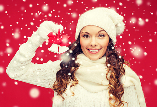 christmas, x-mas, winter, happiness concept - smiling woman in mittens and hat with jingle bells