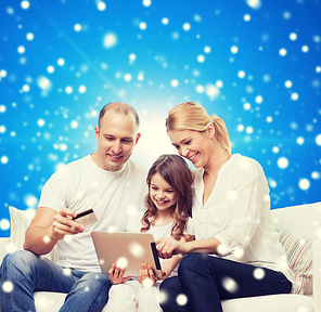family, christmas holidays, shopping, technology and people - smiling family with tablet pc computer and credit card over blue snowy background