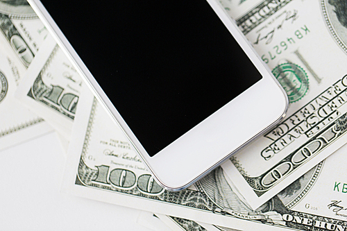 business, finance, technology and e-commerce concept - close up of smartphone with black blank screen and dollar money