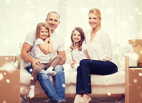 family, people, accommodation and happiness concept - smiling parents and two little girls moving into new home over snowflakes background