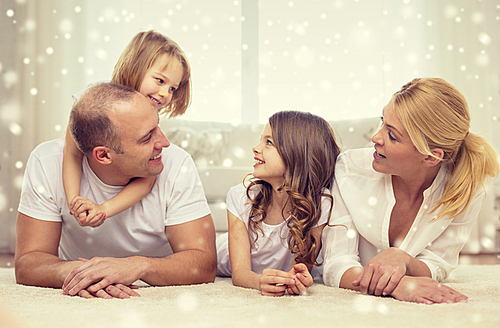 family, childhood, people and home concept - smiling parents with two little girls having fun at home