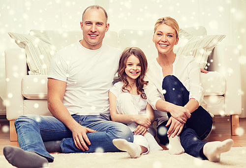 family, childhood, people and home concept - smiling parents with little girl sitting on floor at home