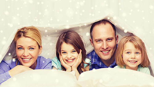 family, children and people concept - happy family with two kids under blanket at home
