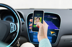 transport, business trip, communication, technology and people concept - close up of male hand with incoming video call icon on smartphone screen in car