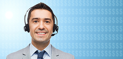business, finances, people, technology and service concept - smiling businessman in headset over blue background with dollar currency symbols