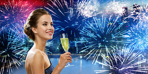 party, drinks, holidays, luxury and celebration concept - smiling woman in evening dress with glass of sparkling wine over nigh city and firework background