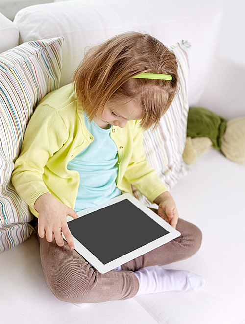 leisure, technology and children concept - little girl with tablet computer at home