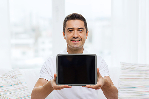 technology, people and lifestyle, distance learning concept - happy man showing tablet pc computer black blank screen at home