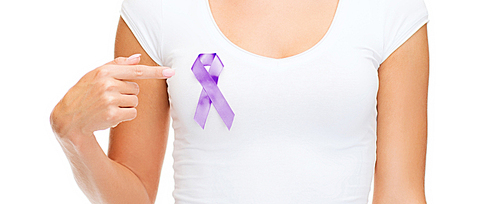 charity, people, health care and social issue concept - close up of woman pointing finger to purple domestic violence awareness ribbon on her chest