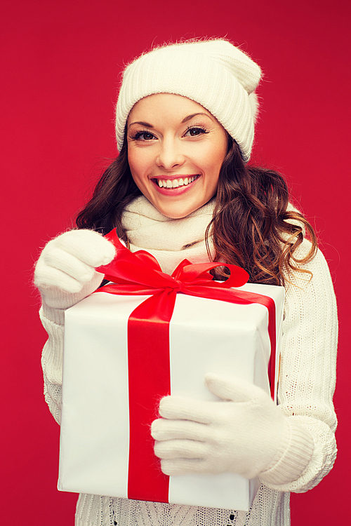 christmas, x-mas, winter, happiness concept - smiling woman in white clothes with gift box