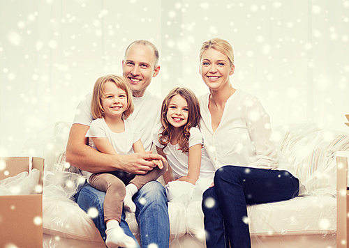 family, people, accommodation and happiness concept - smiling parents and two little girls moving into new home over snowflakes background