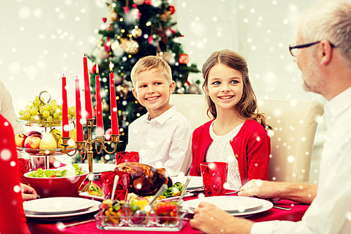 family, holidays, generation, christmas and people concept - smiling family having dinner at home