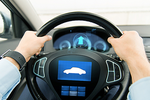 transport, business trip, technology and people concept - close up of male hands holding car wheel and driving with icon on board computer screen